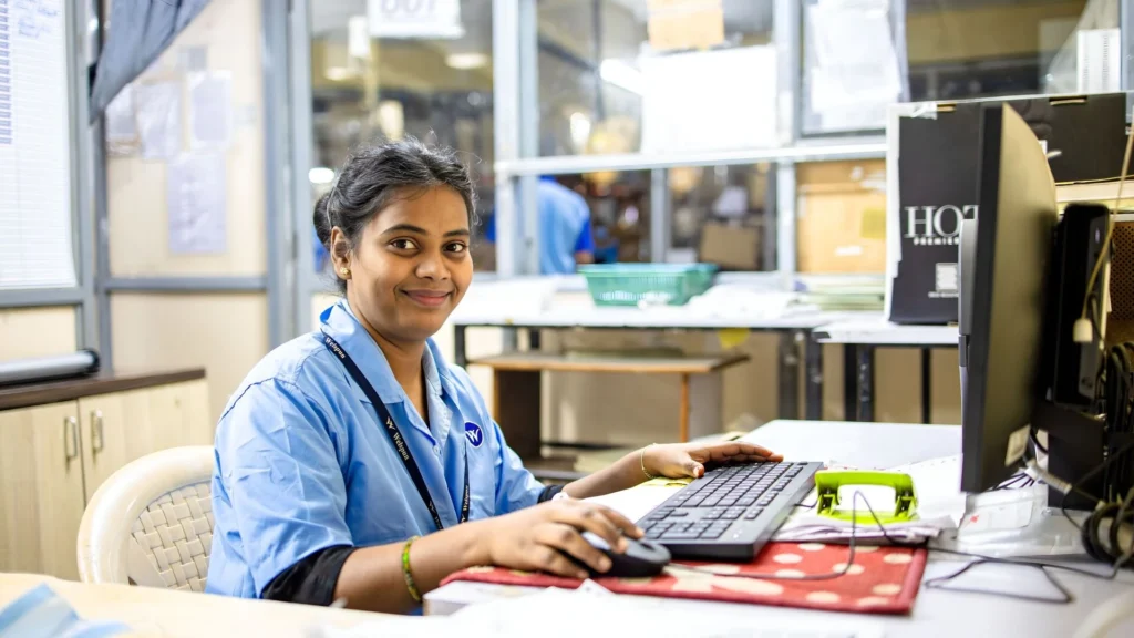Types of CNA Jobs: Certified nursing assistant working at a hospital reception desk.